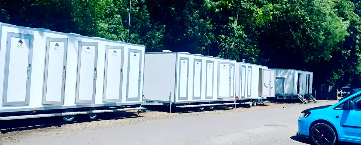 portable shower units in event carpark
